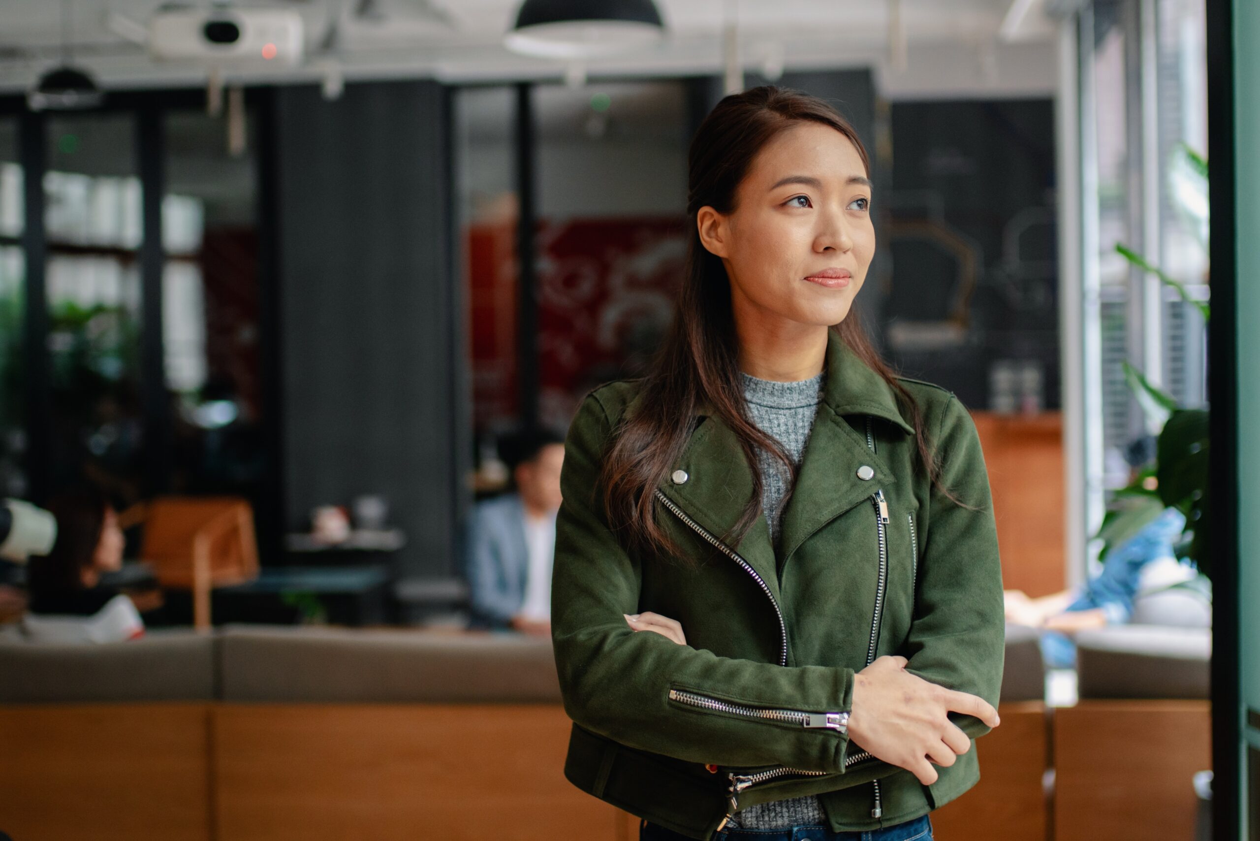 A professional reflecting in a bright office